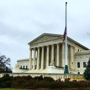 American flag at supreme court against sky