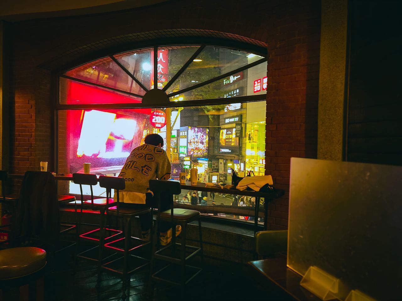 indoors, adult, one person, men, business, table, food and drink, architecture, standing, occupation, window, illuminated, furniture, restaurant, rear view, arts culture and entertainment, seat