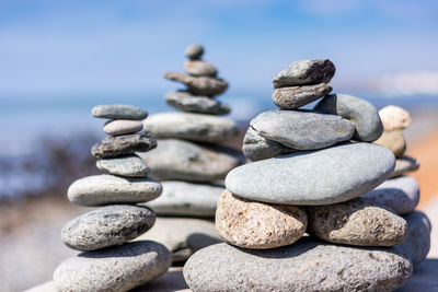 Stack of pebbles on beach against sky