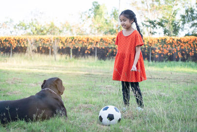 Full length of girl standing on soccer field