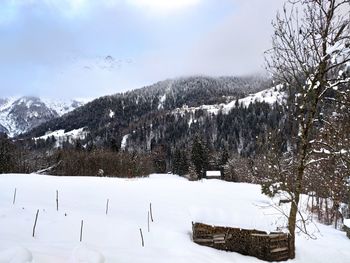 Scenic view of snow covered mountains against sky