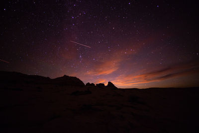 Scenic view of silhouette landscape against sky at night