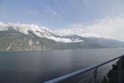 Scenic view of lake by mountains against sky