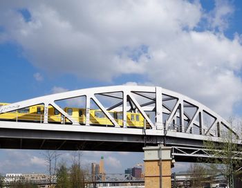 Low angle view of bridge against cloudy sky