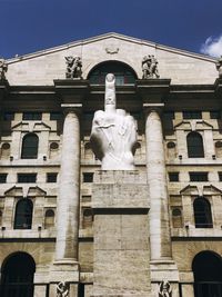 Low angle view of statue against building