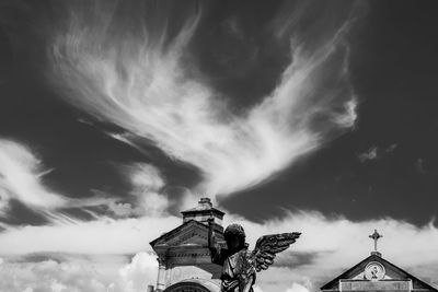 Low angle view of building against cloudy sky