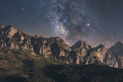 Scenic view of mountain range against star field