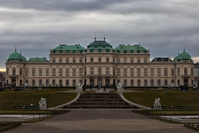 Facade of historic building against cloudy sky