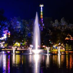 Illuminated fountain at night