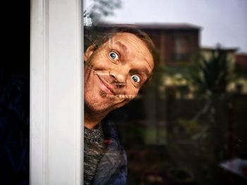 Portrait of young man by window