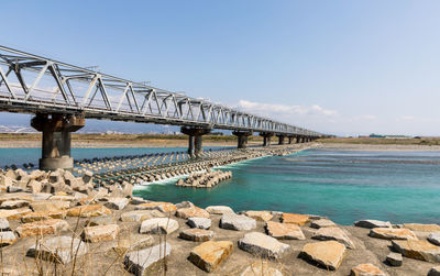 Bridge over sea against sky