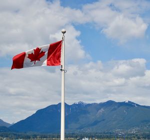 Low angle view of flag against cloudy sky