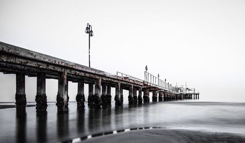 Bridge over river against clear sky
