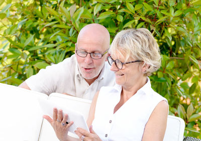 Smiling couple looking at digital tablet