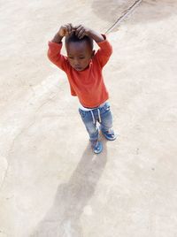 High angle view of cute girl with arms raised