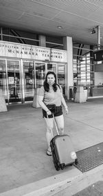 Full length portrait of woman against bus