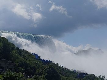 Scenic view of waterfall against sky