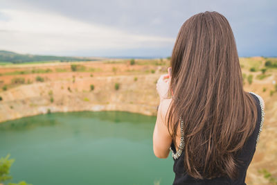 Side view of young woman standing outdoors