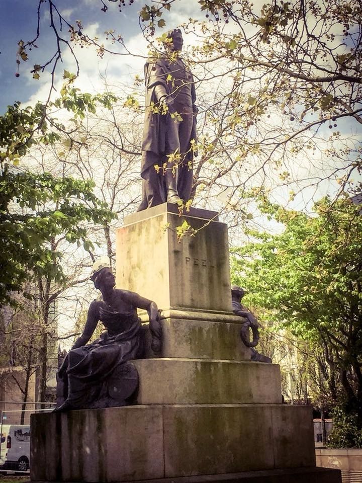 LOW ANGLE VIEW OF STATUE AGAINST TREES AT CEMETERY