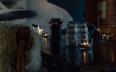 Close-up of illuminated lamp on table at home