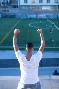 Rear view of man playing soccer