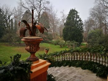Fountain in garden against sky