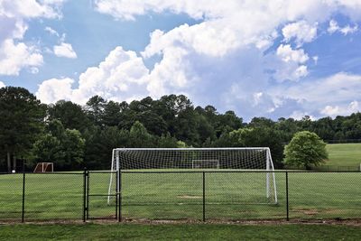 View of soccer field against cloudy sky