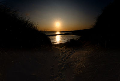 Scenic view of beach against sky during sunset