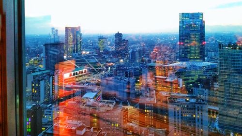 Aerial view of illuminated cityscape against sky at night