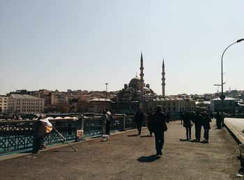Tourists in front of historical building against sky