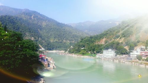 View of calm river with mountain range in background