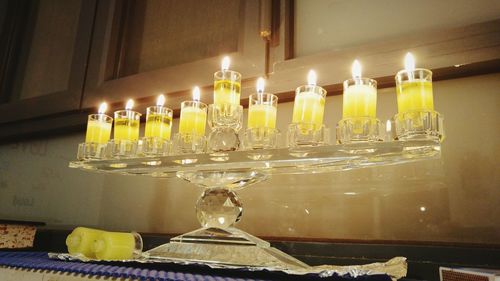 Lit candles on table at home