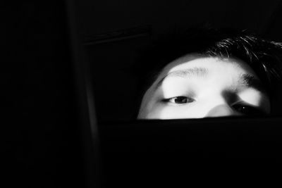 Close-up of young woman reading book at home