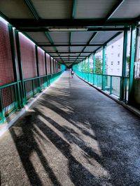 Rear view of man walking in corridor