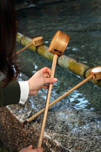 Cropped hands of woman holding ladle