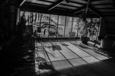 Empty chairs and tables in swimming pool