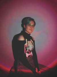 Portrait of young woman standing against sky