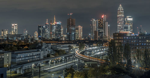 High angle view of illuminated buildings in city at night