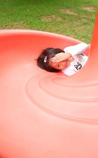 Portrait of girl lying on outdoor play equipment