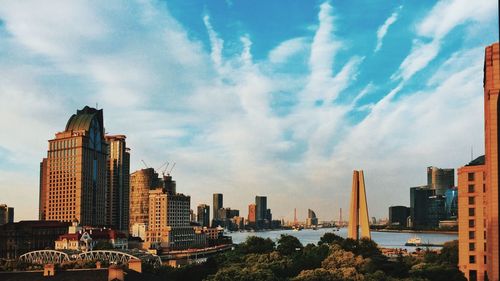 View of cityscape against cloudy sky