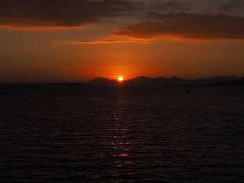 Scenic view of sea against romantic sky at sunset