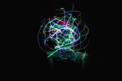 Close-up of light painting against black background