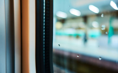 Close-up of illuminated light seen through window