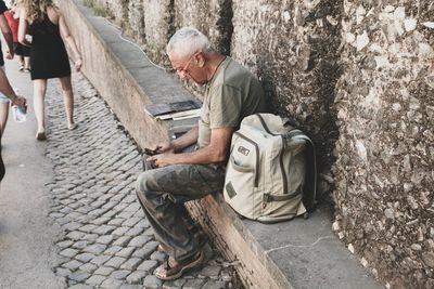 Man working on seat in city