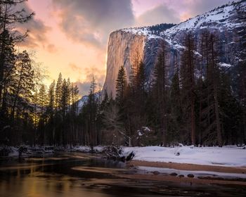 Scenic view of snowcapped mountains against sky during sunset