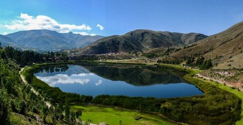 Scenic view of lake and mountains against sky