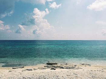 Scenic view of sea against cloudy sky