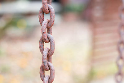 Close-up of rusty chain hanging outdoors