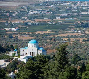 Zia and a blue white village church in front of the turkish mainland in the north on the island kos