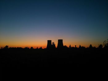 Silhouette of built structures at sunset